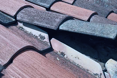 Lifted tiles and damaged Roof flashings